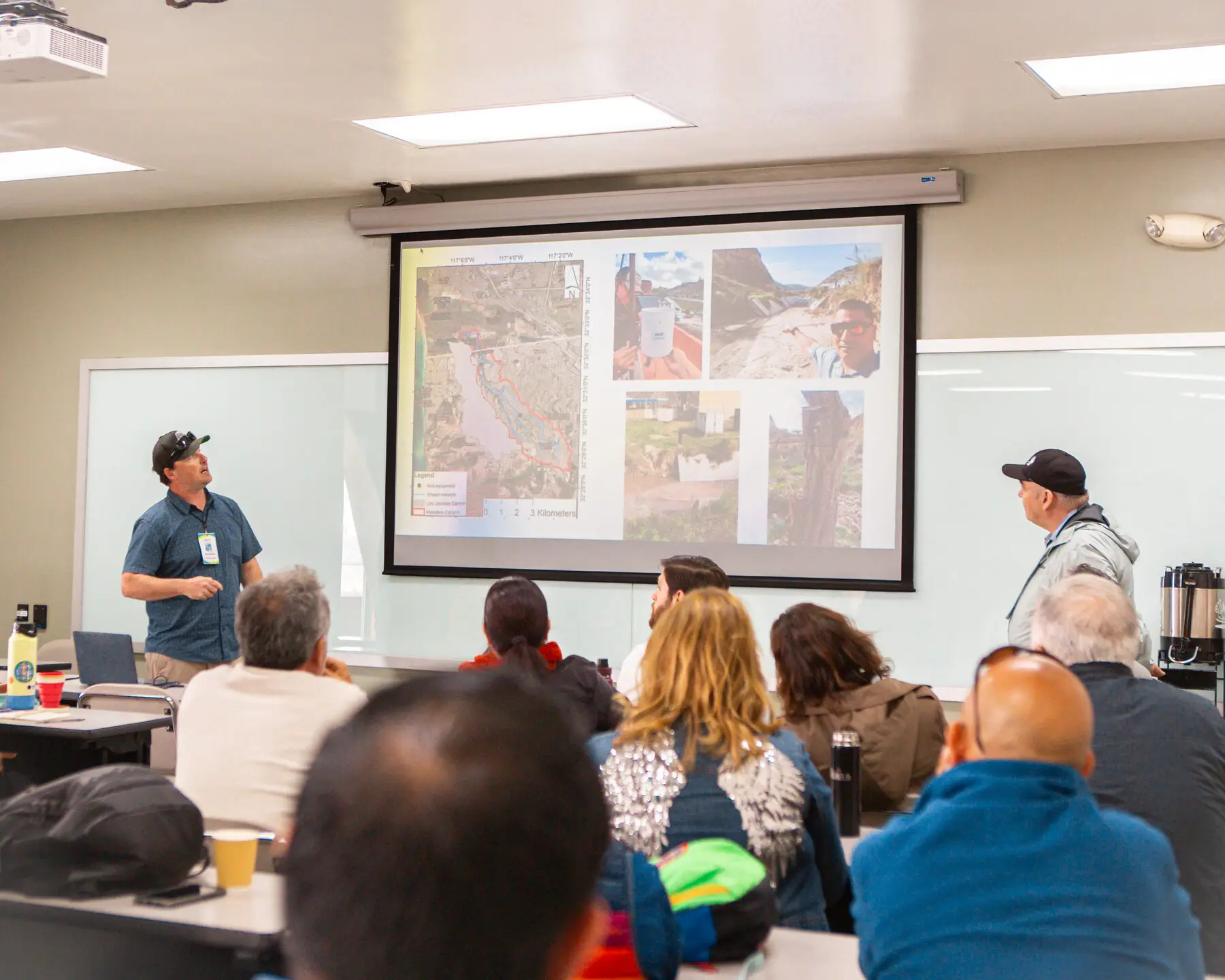 A presenter shares maps and photos with a network meeting