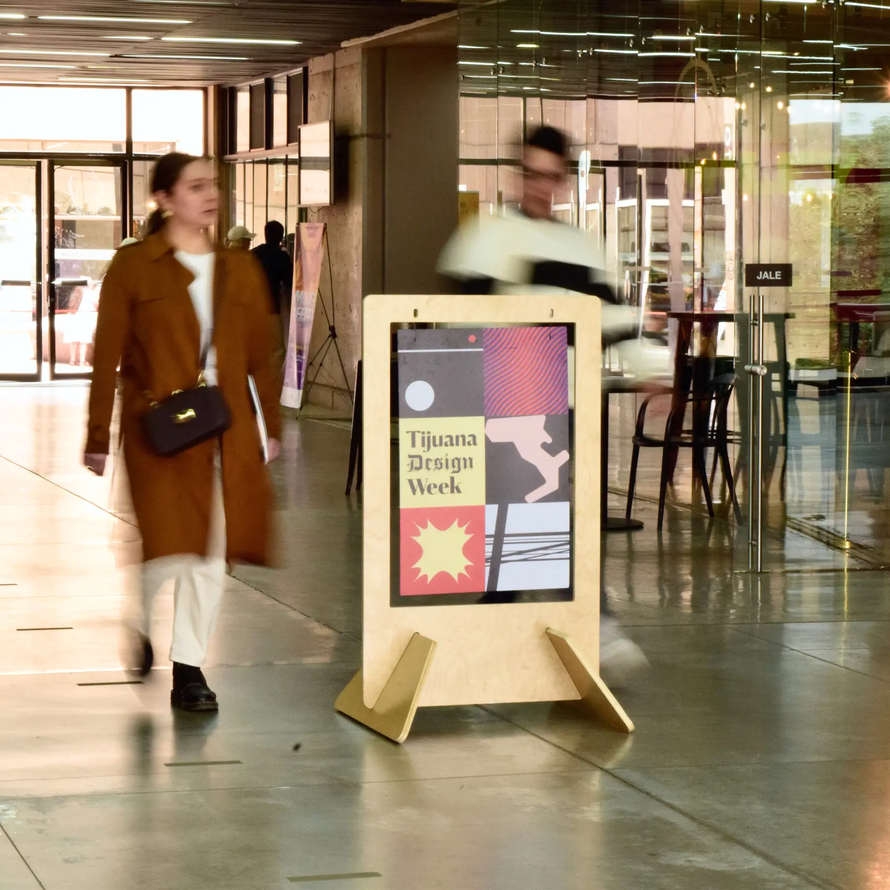 A visitor walks past a Tijuana Design Week sign
